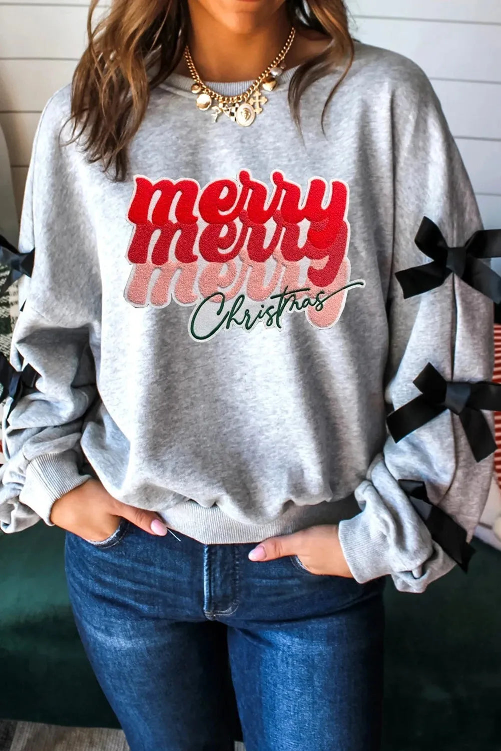 Women's light gray long sleeve ribbon slit letter shirt pullover front view on model