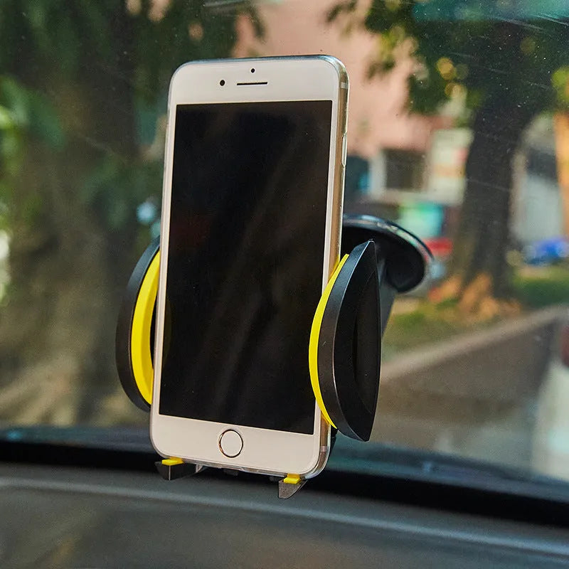 Red U-shaped suction cup car phone holder with wide clamp open, mounted on a car dashboard.