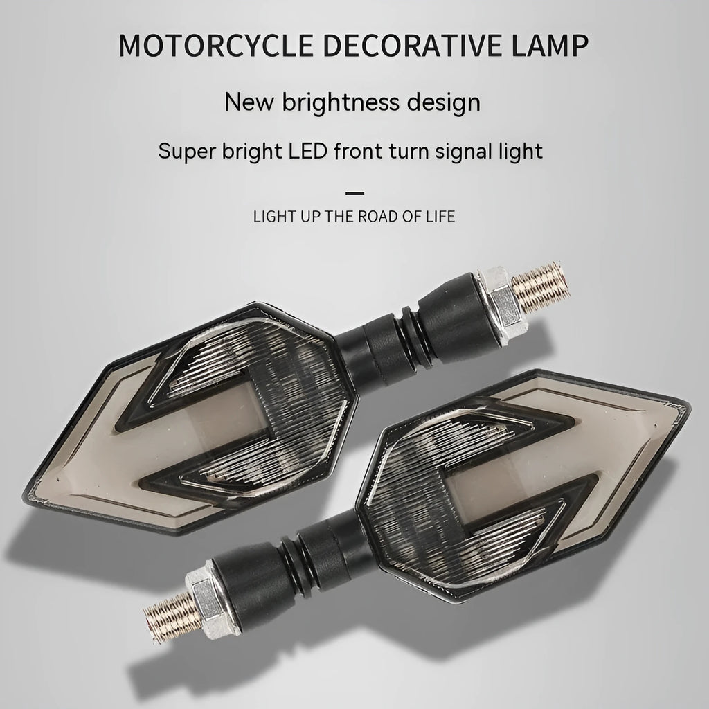 Arrow-shaped LED motorcycle turn signal light unit for 12V vehicles, shown in available colour options.