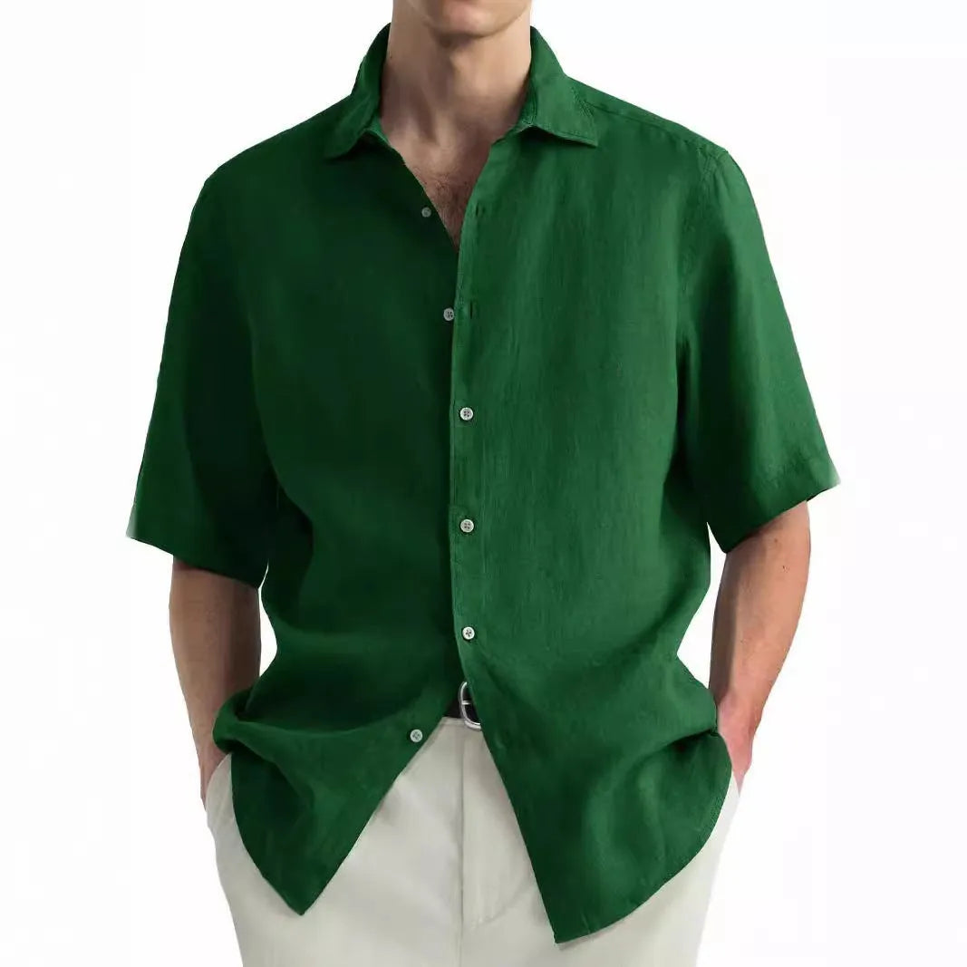 A man wearing a green washed cotton casual shirt in a cardigan style with a regular fit.