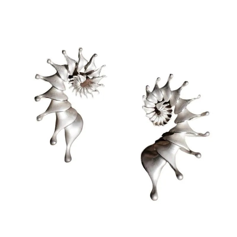 A pair of alloy conch-coloured stud earrings with an irregular three-dimensional shape and a matte finish.