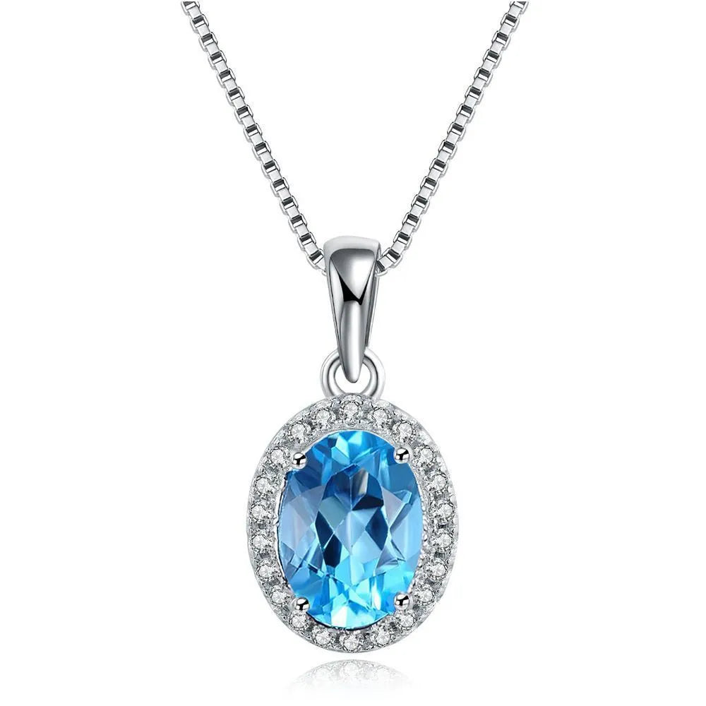 Geometric design women's sterling silver and blue topaz jewellery set showing earrings, ring, pendant, and necklace.