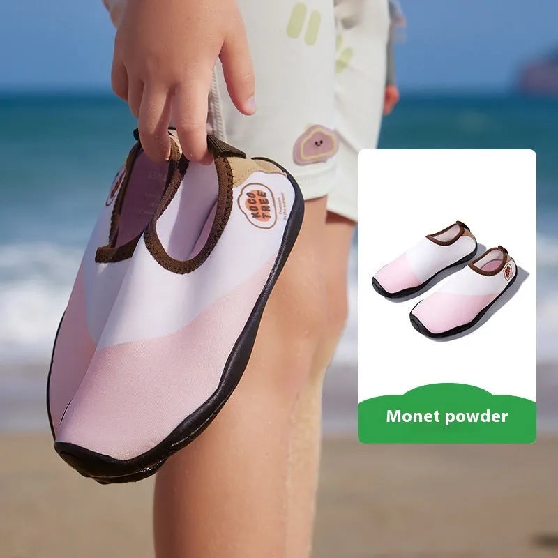 Children's anti-slip beach shoes in assorted colours with rubber soles and polyester fibre uppers.