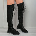 Black lace-up over-the-knee boots with a round toe and flat rubber sole on a neutral background.