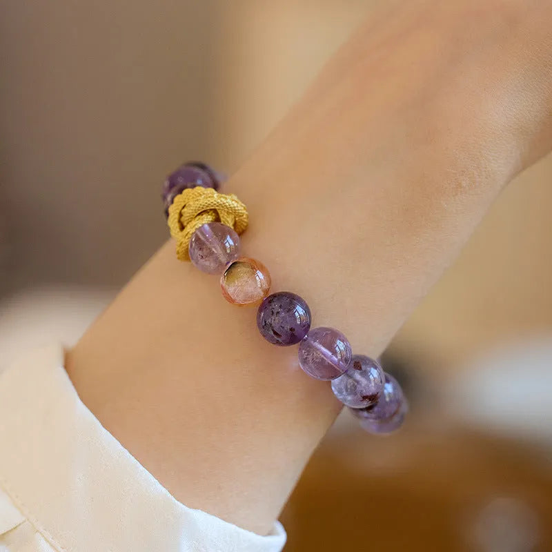 Purple cornucopia nine purple good luck crystal bracelet with zodiac animal motifs on wrist