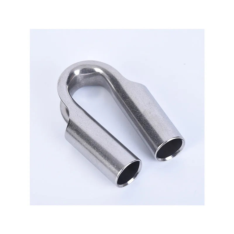 Set of stainless steel tubular chicken heart sleeve rings in various sizes on a workbench.