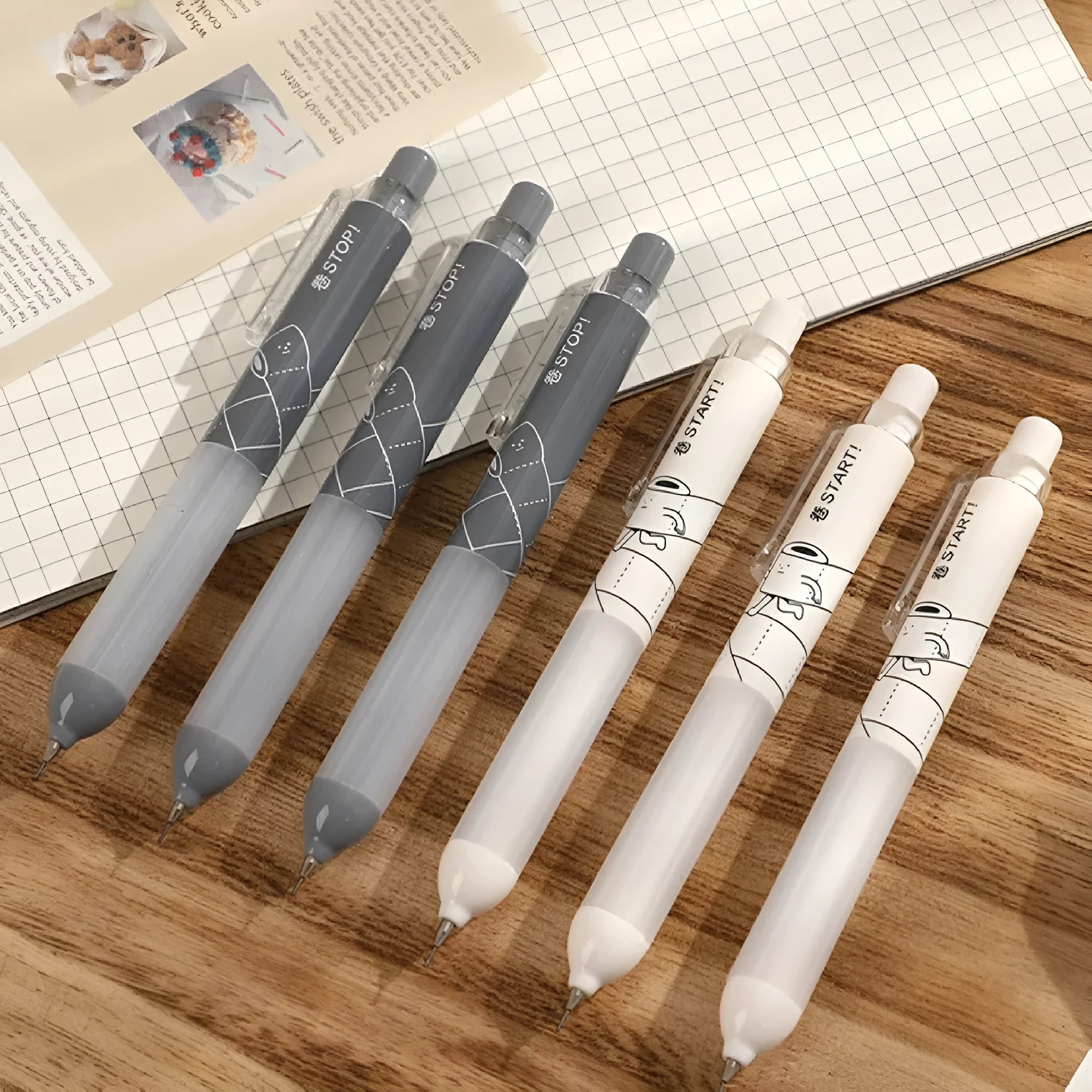 Two 0.5mm mechanical pencils with soft cloud grips, one black and one white, on a plain background.