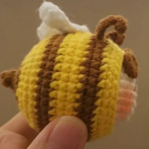 Handmade crocheted bee colony wool doll with bee pendant accessory in plush soft toy construction