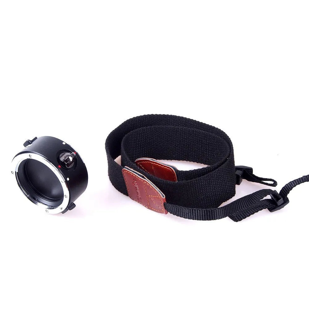 Aluminium camera lens flipper holder with two lenses attached on a cotton shoulder strap.