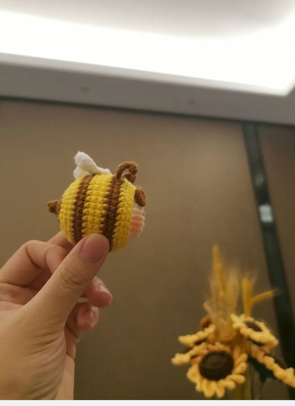 Handmade crocheted bee colony wool doll with bee pendant accessory in plush soft toy construction