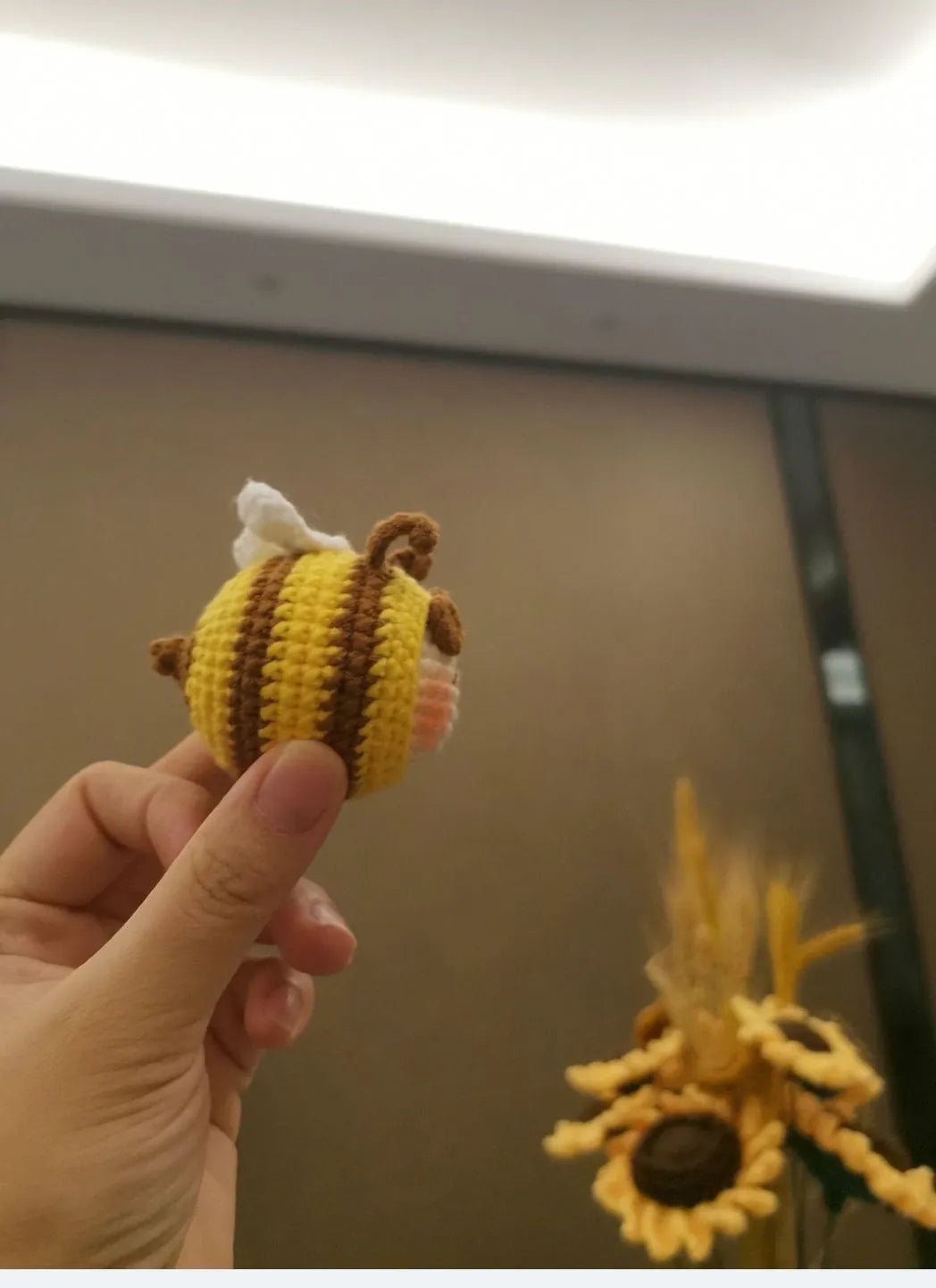 Handmade crocheted bee colony wool doll with bee pendant accessory in plush soft toy construction
