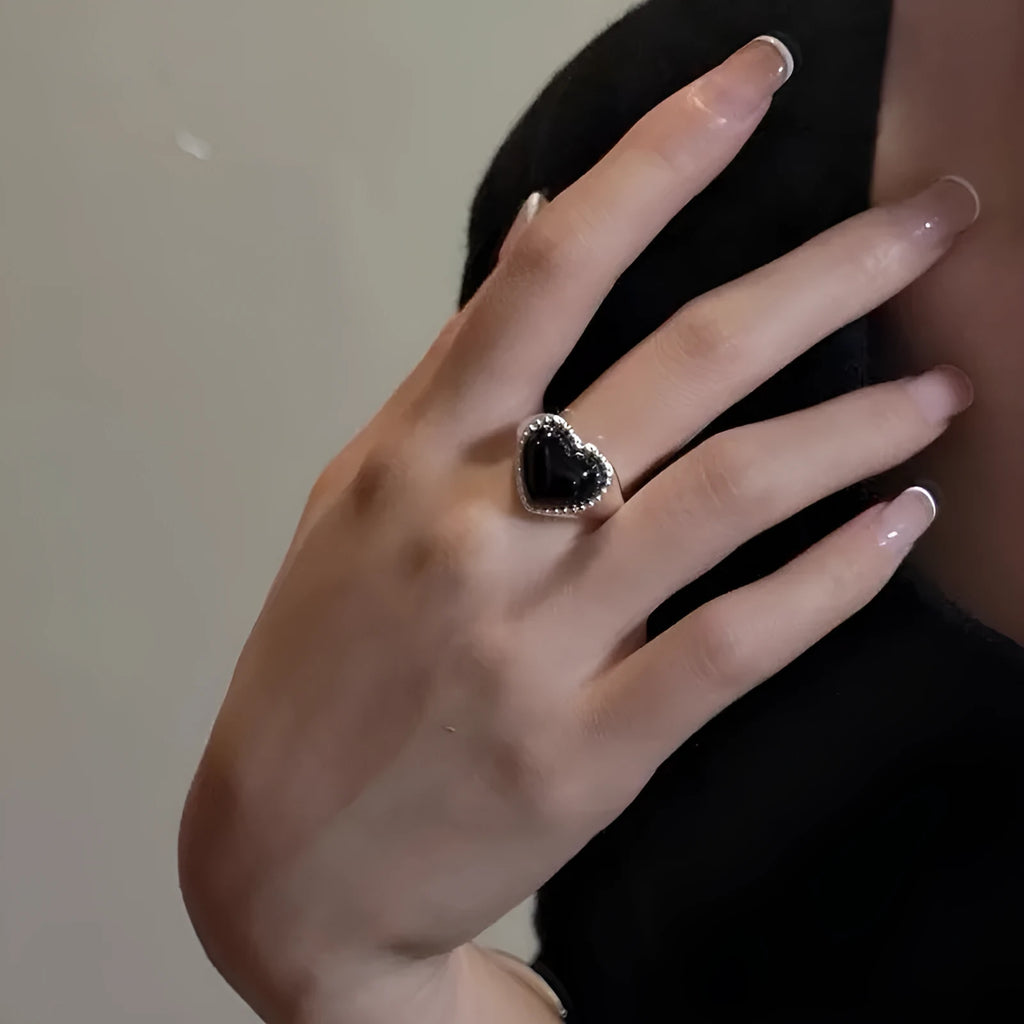 Black agate heart ring in sterling silver with an adjustable open mouth design.