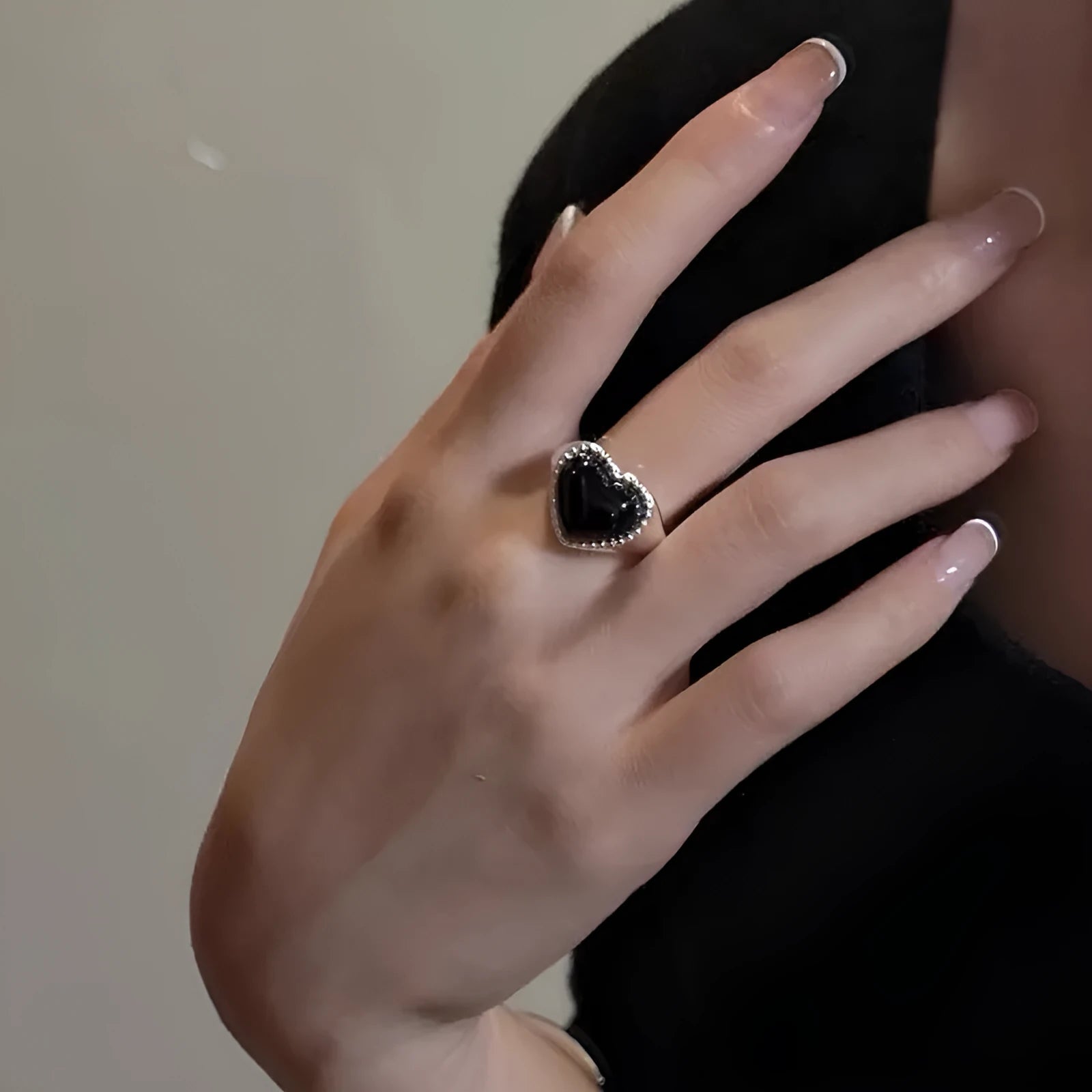 Black agate heart ring in sterling silver with an adjustable open mouth design.
