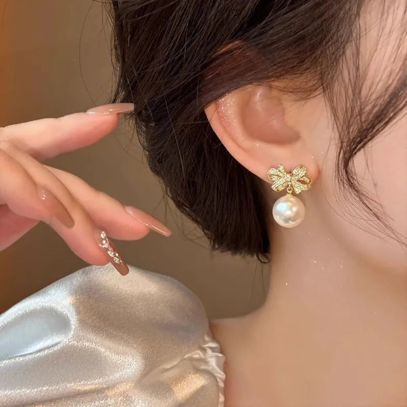 Gold tone bow pearl stud earrings, 12mm alloy women's earrings supplied as one pair