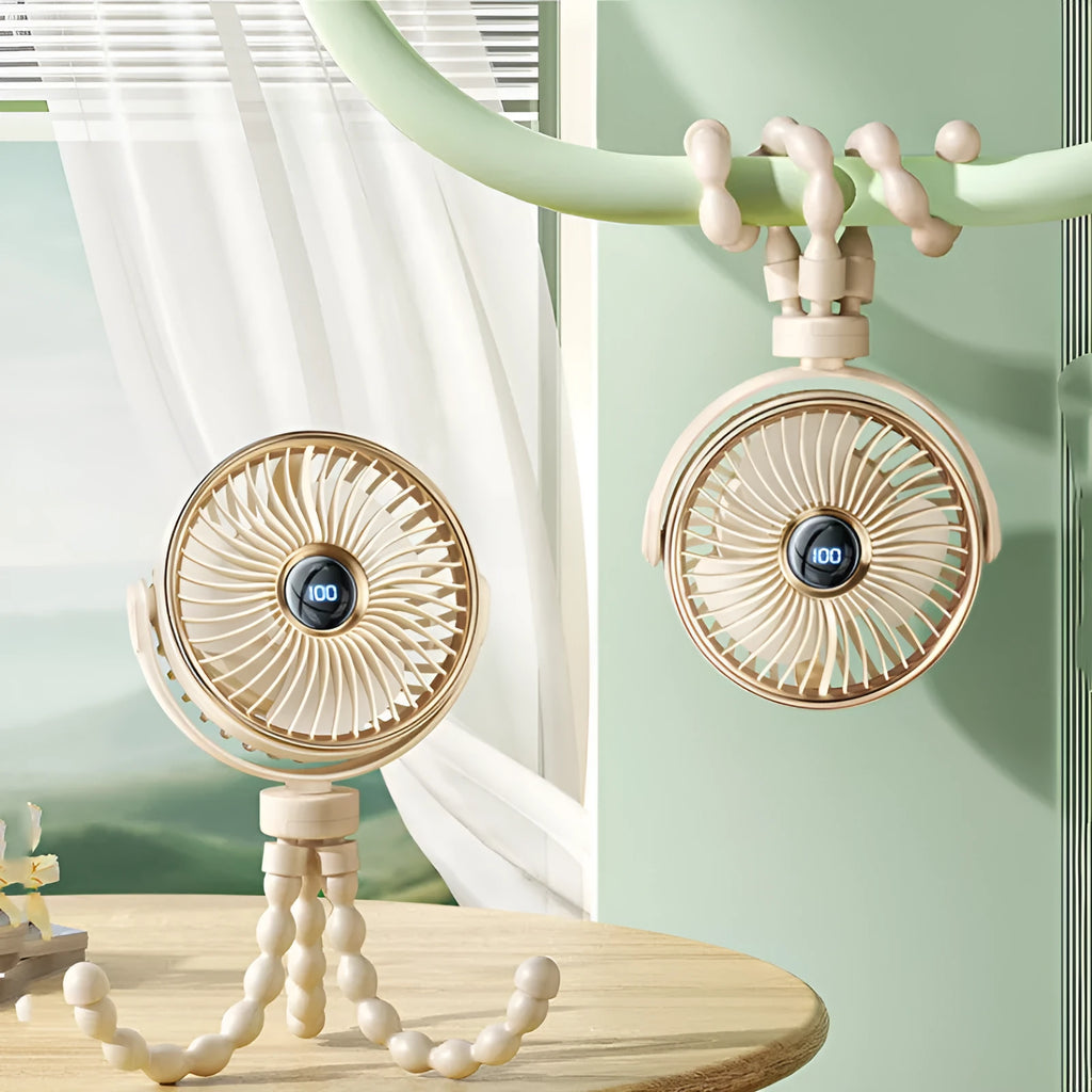 A beige portable clip-on fan with three blades, mounted on a stroller handle, showing its rotating head.