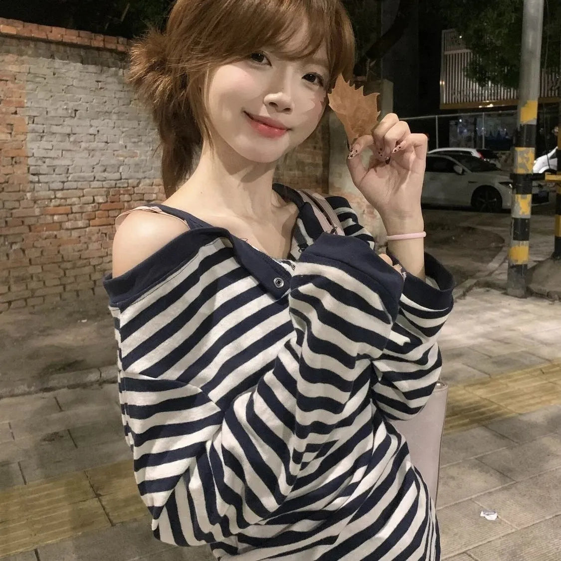 Dark blue women's oversized long-sleeved T-shirt with embroidery and stripes, laid flat.