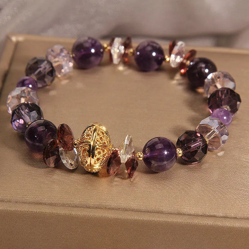 Purple crystal bracelet with pumpkin-shaped beads and rhinestone accents on a wrist.
