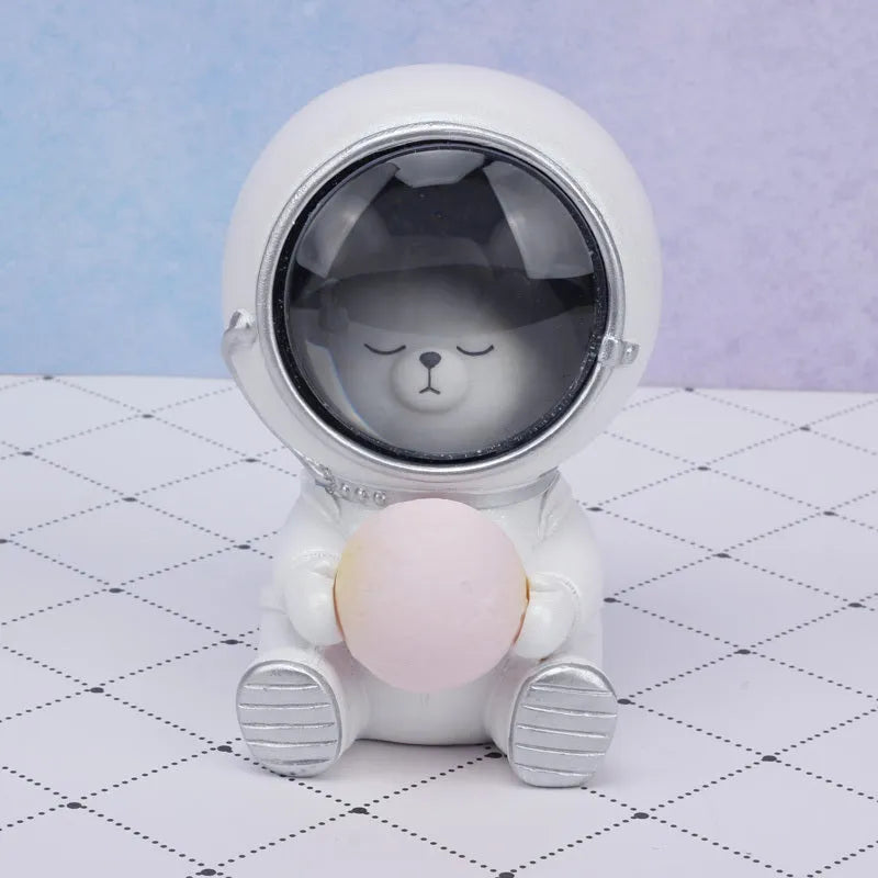 Resin bear-shaped starry sky night light with soft LED glow on a wooden table.
