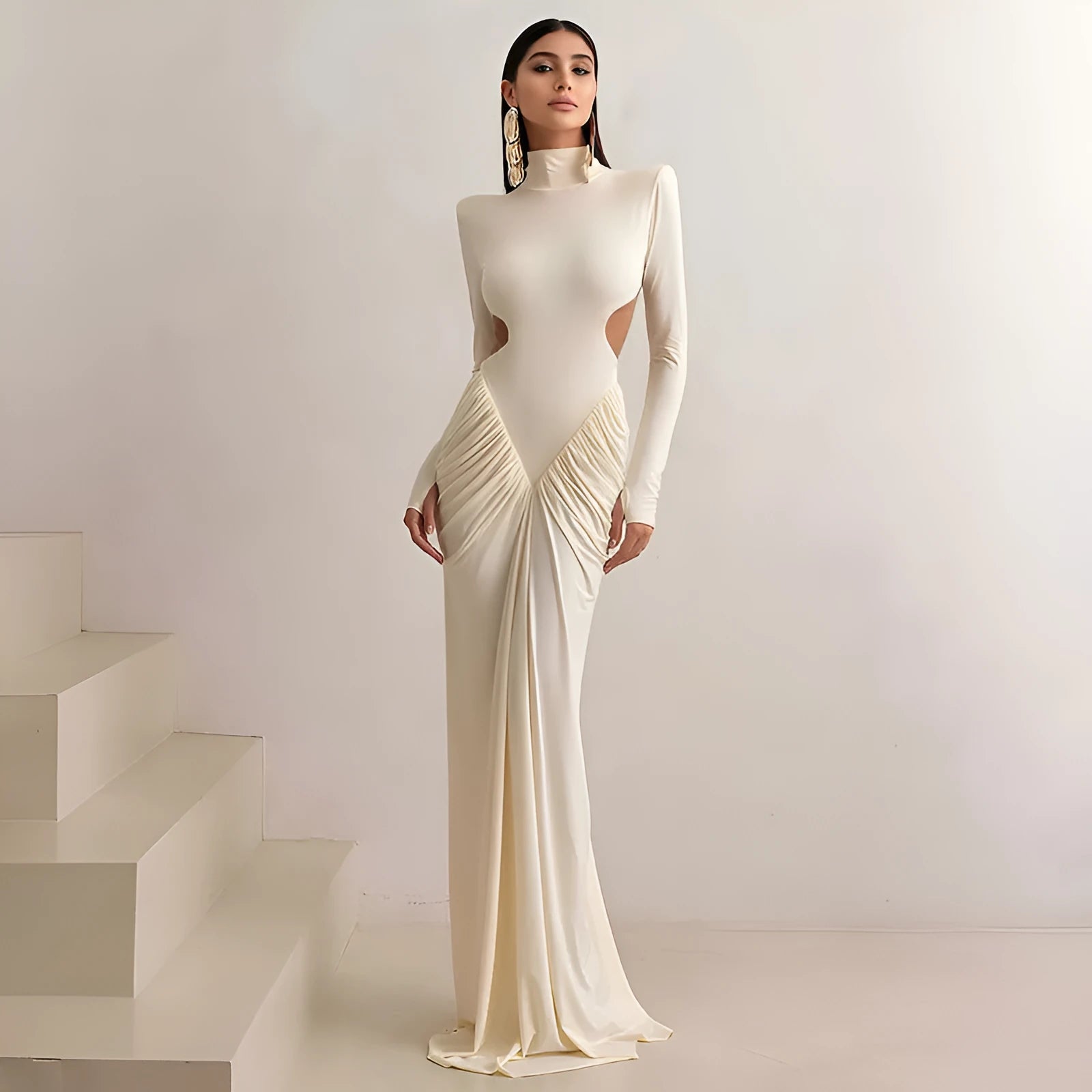 A woman's long sleeve high collar slim fit dress in a solid colour with a pleated backless detail.