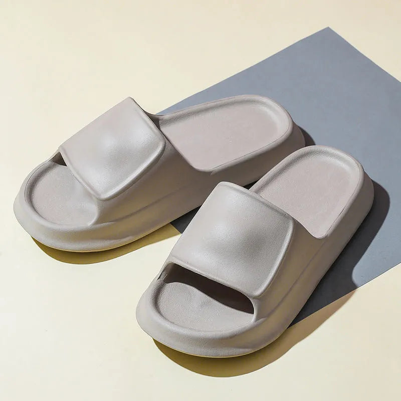 Pair of thick-soled white EVA flip-flop slippers with a non-slip patterned sole.