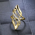 Women's exaggerated curve statement ring in gold colour with bold design on finger