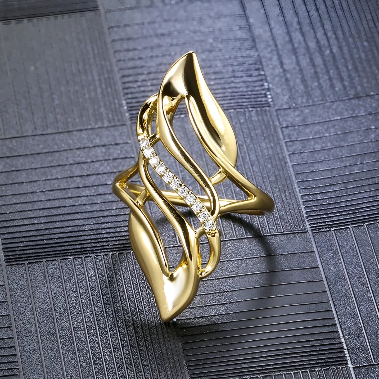 Women's exaggerated curve statement ring in gold colour with bold design on finger