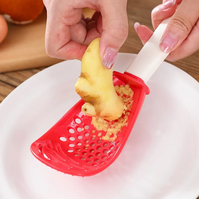 Red and black plastic multifunctional cooking spoon with grinding serrations and half-enclosed design
