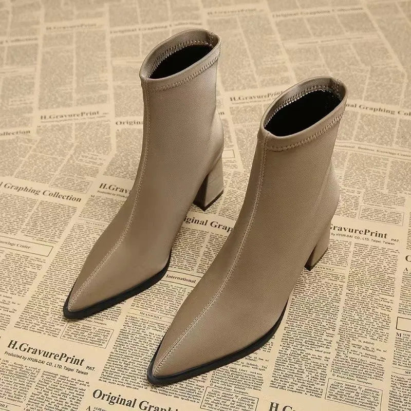 Women's khaki stretch artificial velboa ankle boots with a wedge heel and pointed toe on a plain background.