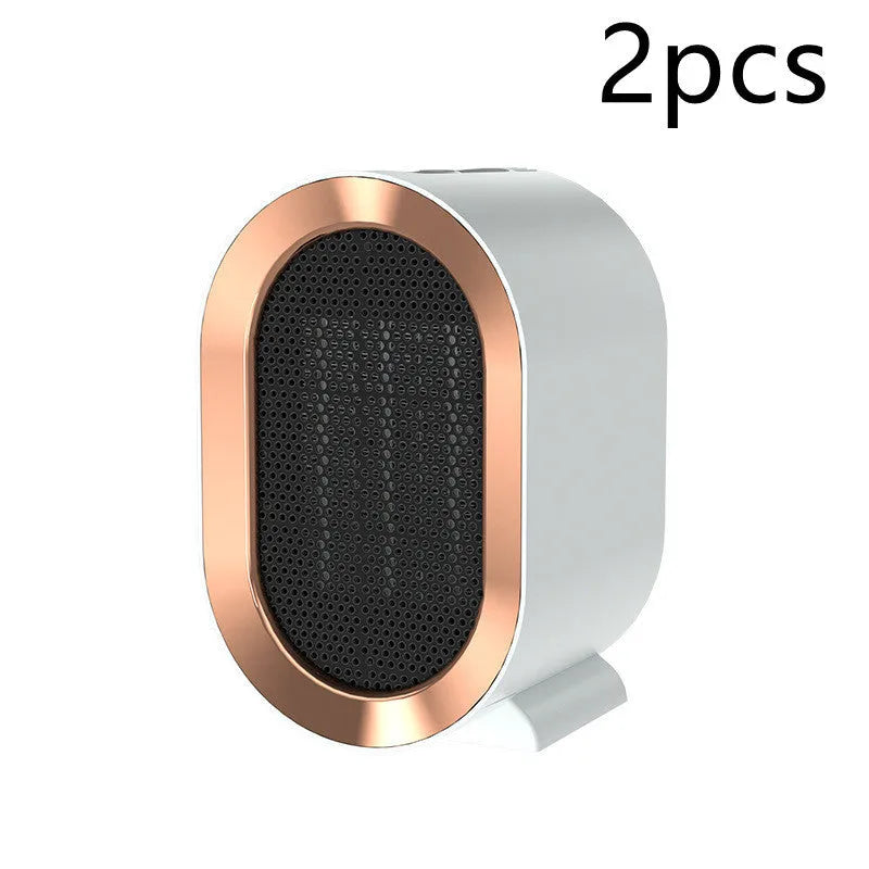 Compact desktop ceramic fan heater in black on a wooden desk.