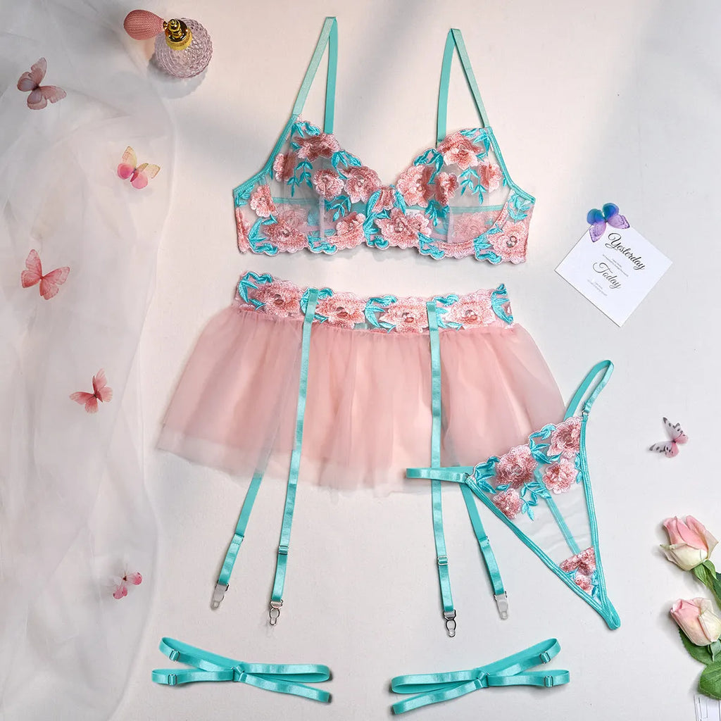 Pink women's bikini set with embroidered mesh pettiskirt and matching strappy top.