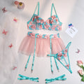 Pink women's bikini set with embroidered mesh pettiskirt and matching strappy top.