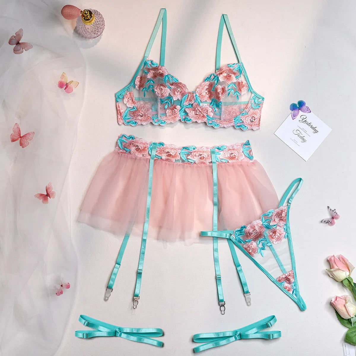 Pink women's bikini set with embroidered mesh pettiskirt and matching strappy top.