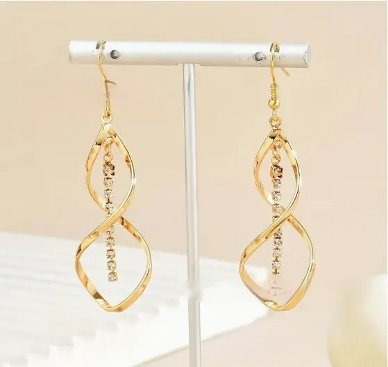 Women's gold alloy earrings with creative spiral design featuring geometric shapes and elliptical elements