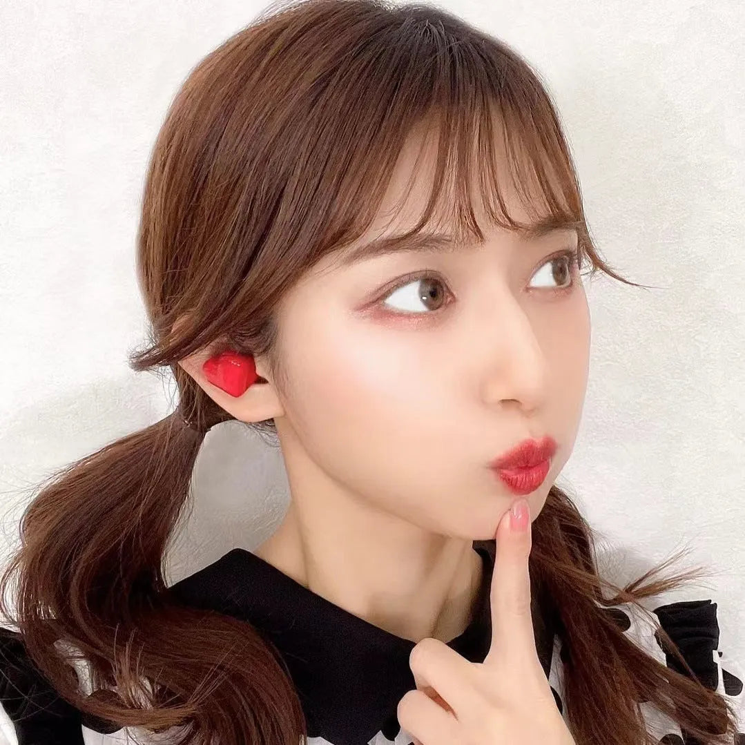 Heart-shaped wireless Bluetooth earphones in Chinese red and girl pink colours with charging cable
