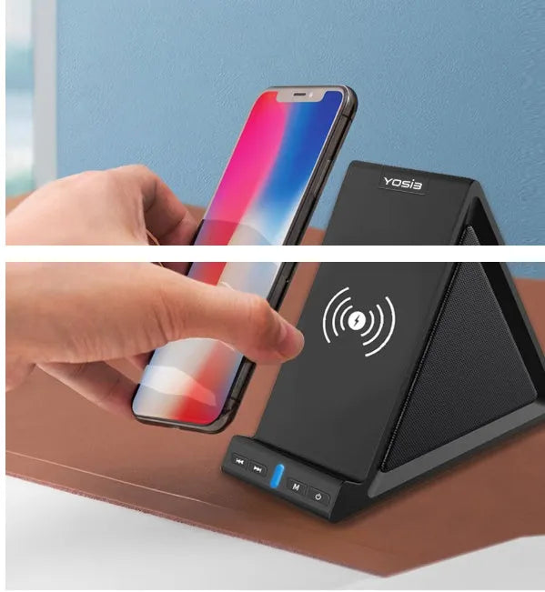 Black multifunctional power bank with integrated Bluetooth speaker and wireless charging phone stand on a desk.