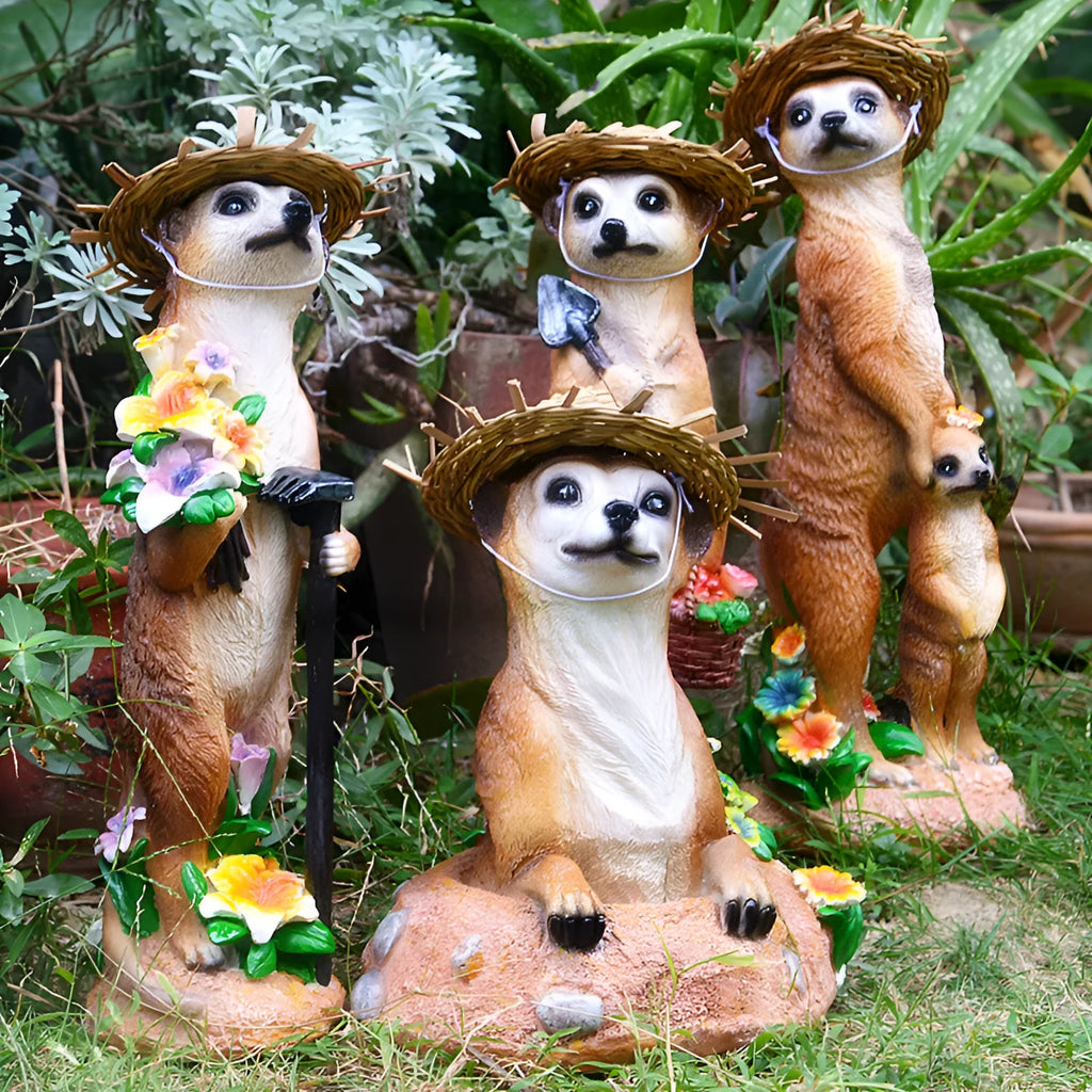 Three straw hat mongoose garden ornaments including mother and child grouping plus figures with rake and shovel