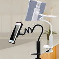 Black flexible magnalium mount holder with suction base holding a mobile phone at an angle.