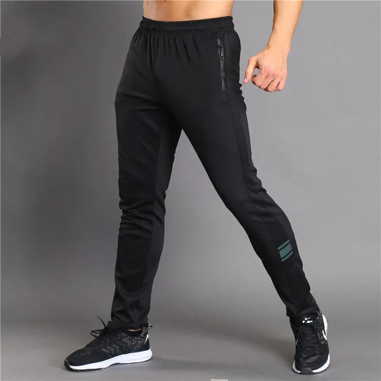 Black slim-fit running fitness trousers with reflective printing and zipper pockets on a model