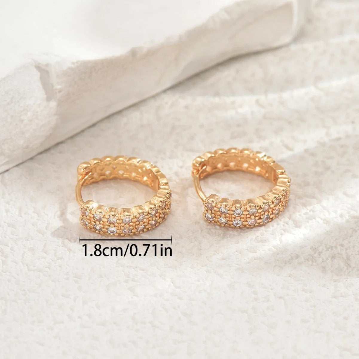 A pair of women's copper geometric ear studs with a dot and ring design, shown against a plain background.
