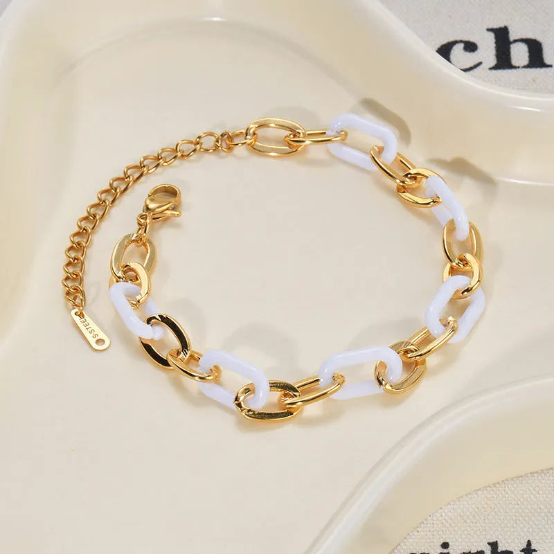Silver stainless steel bracelet for women with a double-layer red resin heart charm.