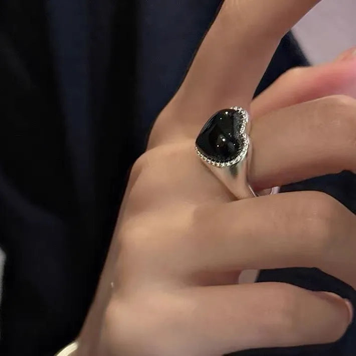 Black agate heart ring in sterling silver with an adjustable open mouth design.
