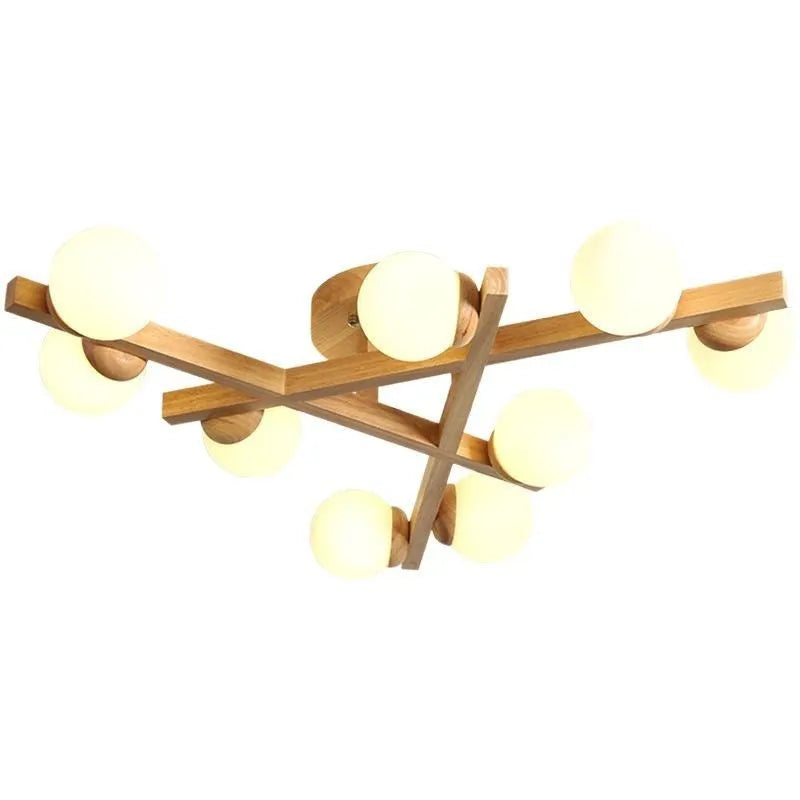 Modern black and copper three-headed pendant ceiling light with adjustable arms hanging over a wooden table