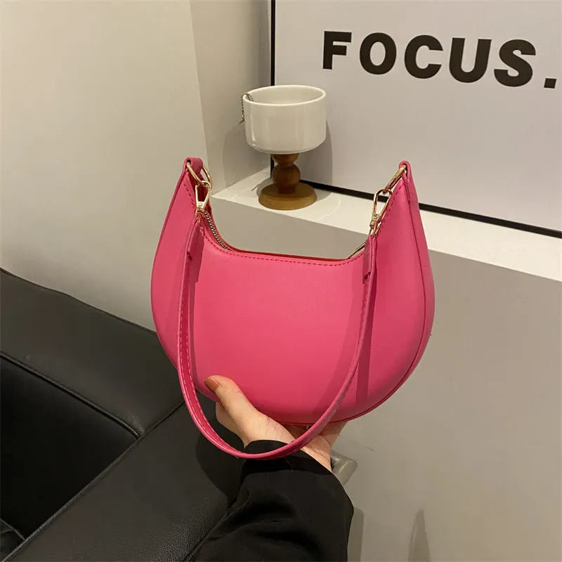Round green one-shoulder underarm bag with visible sewing lines and sandwich-style compartments