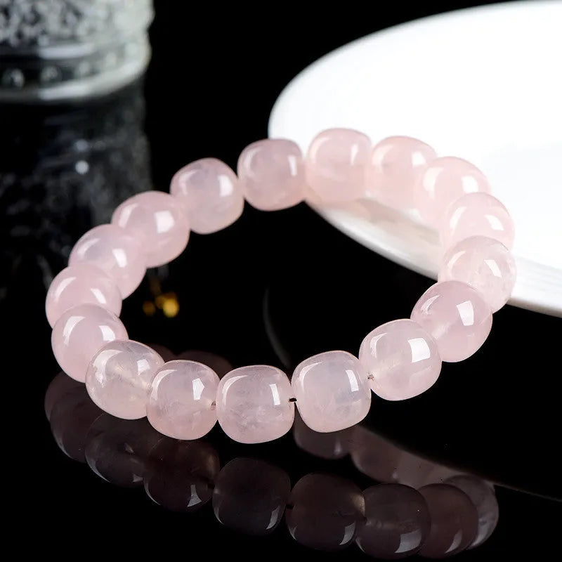 Pink crystal bamboo bracelet with 11x12mm geometric barrel beads on a wrist.