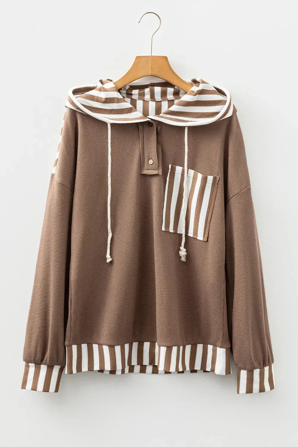 Straw yellow hoodie with waffle texture, striped patchwork, a button neck, and a drawstring hood.