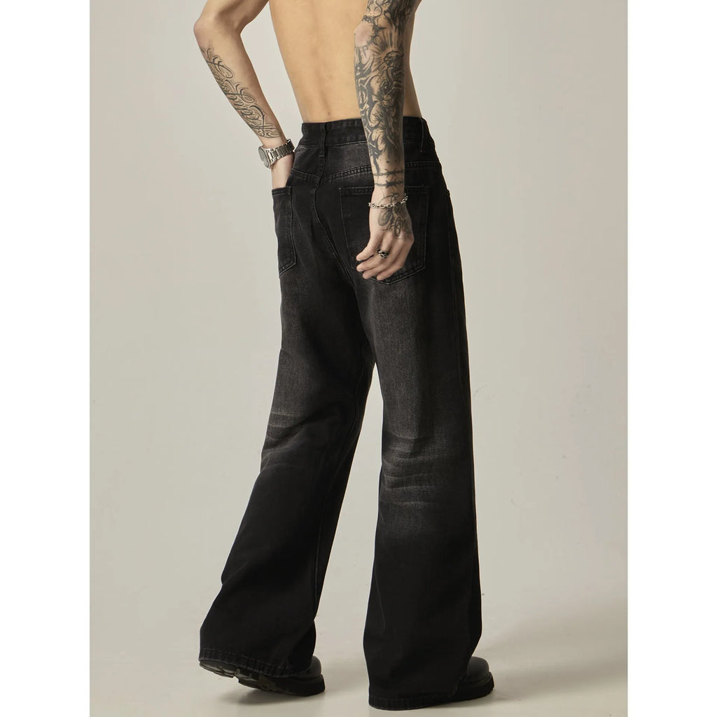 A pair of black loose-fit straight-leg jeans with a retro style on a white background.