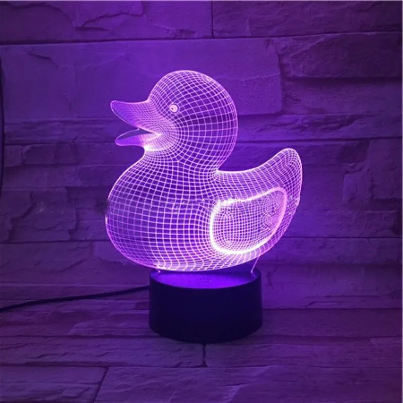 Little yellow duck 3D night light on a table, showing its cartoon design and colourful LED glow.
