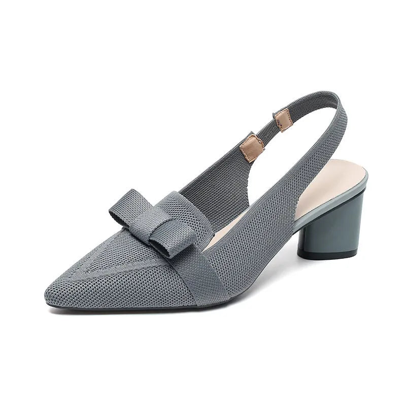 Women's black closed toe high heel sandals with a bow detail and an ankle strap on a rubber sole.