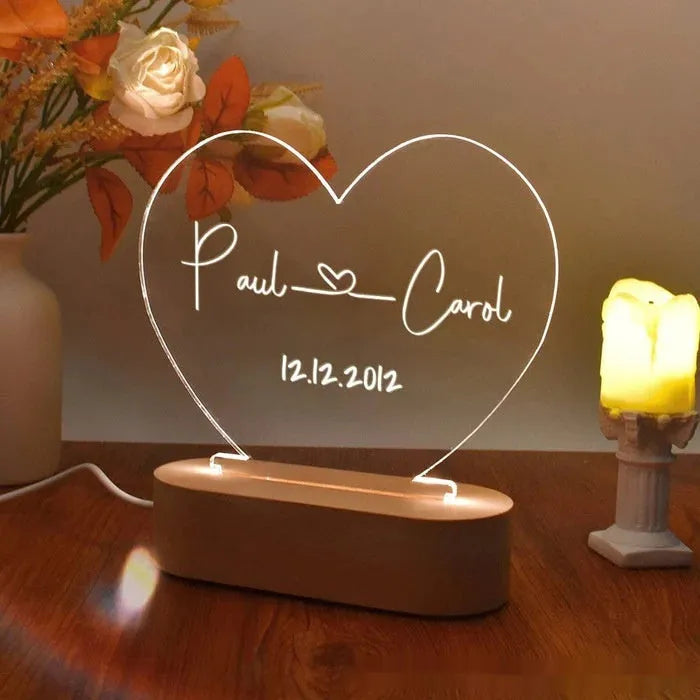 Custom clear acrylic night light displaying personalised names and date, lit by an LED base.