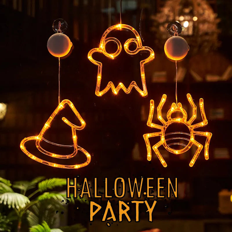 Halloween battery-powered LED window lights with spider, pumpkin and ghost figures hung by suction cups.